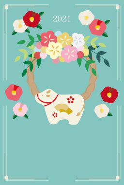 Bir inek bebeği, bir dekorasyon ve kamelya çiçeğiyle yılbaşı resmi..