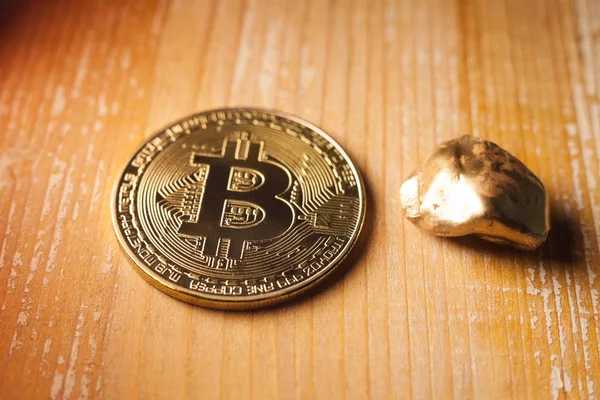 bitcoin and golden nugget on wooden background