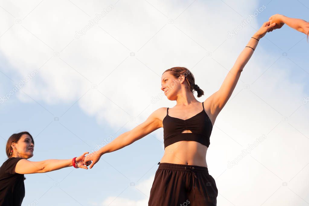 young women holding hands