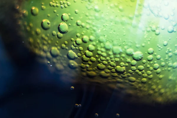 Air bubbles on a piece of ice in a soda liquid. Soda, water, bubbles, ice, texture, glass, glass, curve,