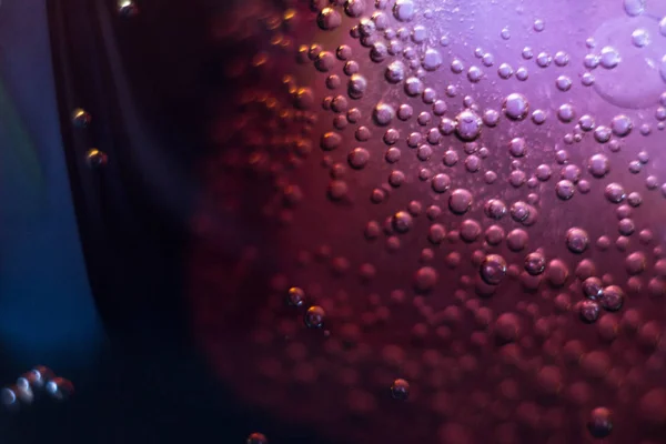 Air bubbles on a piece of ice in a soda liquid. Soda, water, bubbles, ice, texture, glass, glass, curve,