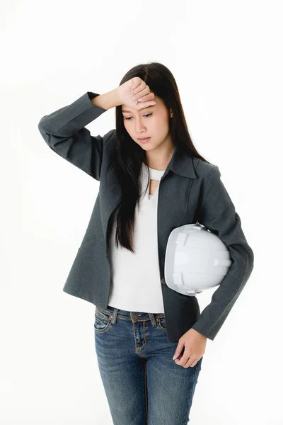 Construction expert and interior Asian women  hold in white hat her hand acting tired to working studio shot isolated on white background.