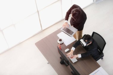 Genç iş adamı, sanal gerçeklik sunumunu izlemek için maske takan orta yaşlı iş adamının yanında defter tutuyor. Vr, yakın gelecekte yaygın olarak kullanılan yeni bir teknolojidir..