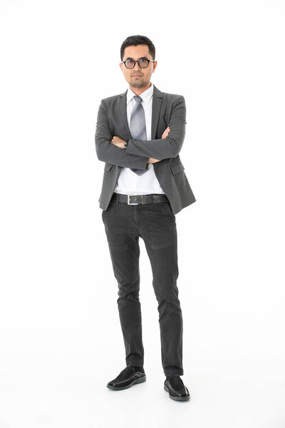 Full length portrait of young, handsome, Asian, businessman, wearing eyeglasses in business suit, standing arms crossed, confidently look at camera, on isolated white background