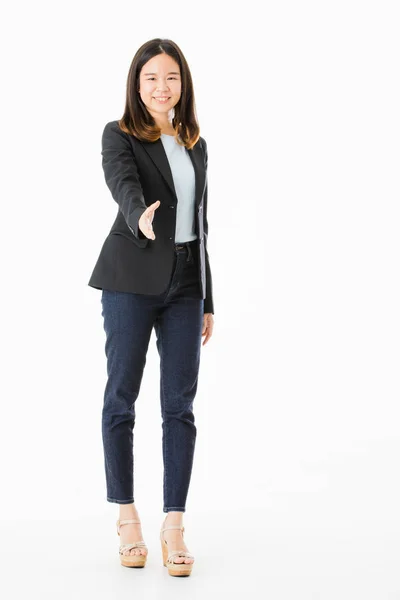 Shot of young, beautiful, Asian lady, long black hair, in smart casual, standing, smiling and hold out hand in handshake for greeting and welcome gesture, on isolated white background