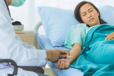 Erkek doktor kadın hasta için ilaç enjekte ediyor..