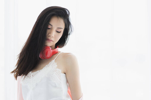 Asian black hair woman wearing red headphone