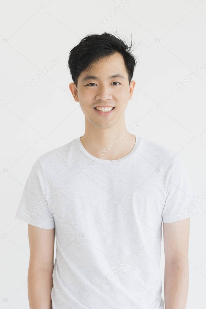 Young Asian man model in T-shirt crossed arm