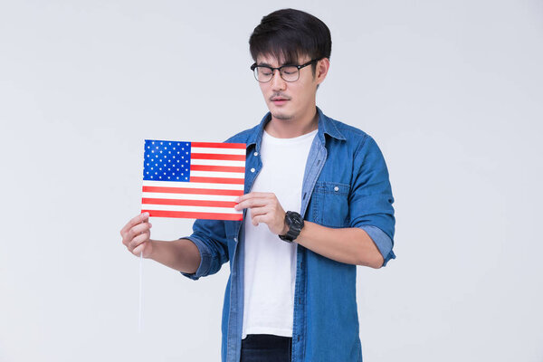 Asain man holding American flag.