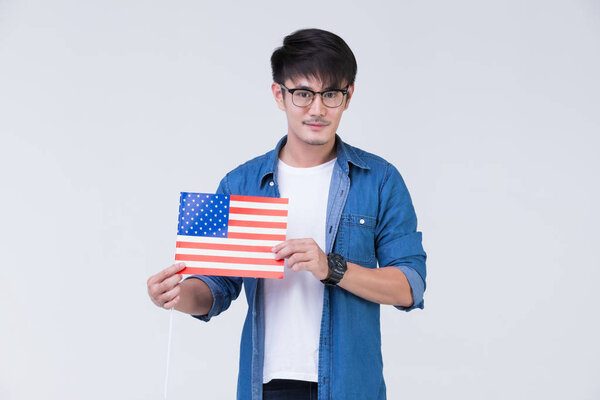 Asain man holding American flag.