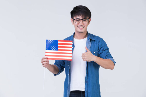 Asain man holding American flag.