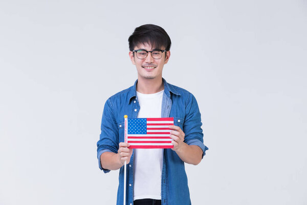 Asain man holding American flag.