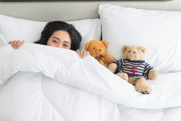 Aziatische vrouw slaapt op bed met twee teddy beer — Stockfoto