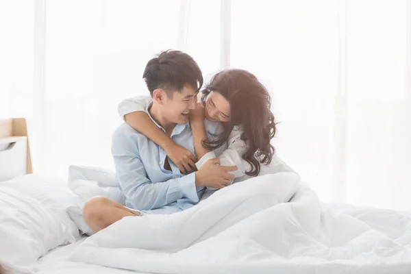 Couple sitting on bed, they hug each other by love — Stock Photo, Image