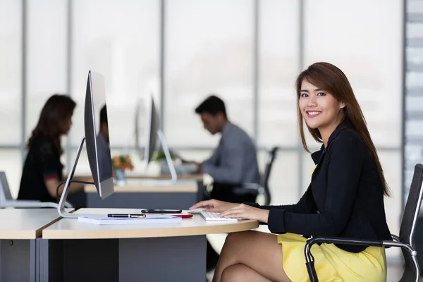 Asiática mujer de negocios sentado y sonrisa en la oficina —  Fotos de Stock
