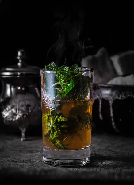 Moroccan tea cup with mint in dark background, The marocain a la menthe fond noir