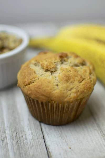 Banana Nut Muffin Flat Lay with Bananas and Walnuts on Wood Background Close up