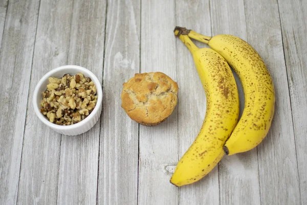 Banana Nut Muffin Flat Lay with Bananas and Walnuts on Wood Background