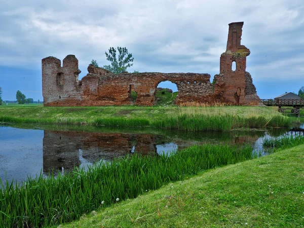 Ruins by the water.   Besiekiery, Poland - May 10, 2020   Ruins of a medieval knight\'s castle surrounded by water in the village of Besiekiery.