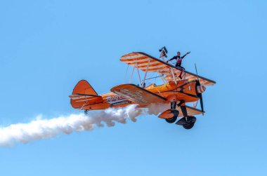SOUTHPORT, UK JULY 8 2018: Two world famous Aerosuperbatics Wing Walkers from The Flying Circus thrill the crowds in the skies above Southport Beach for the annual Air show clipart