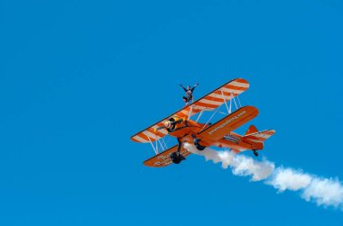 SOUTHPORT, UK JULY 8 2018: Two world famous Aerosuperbatics Wing Walkers from The Flying Circus thrill the crowds in the skies above Southport Beach for the annual Air show clipart
