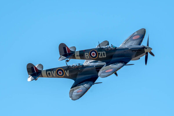SOUTHPORT, UK JULY 8 2018: Two ex-RAF Spitfires perform a two ship display in the clear skies above Southport Beach for the annual airshow