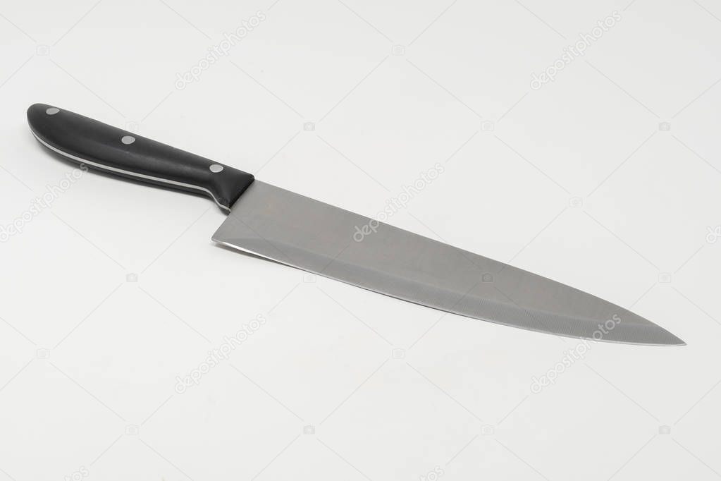 An angled stainless steel kitchen knife set against a white background