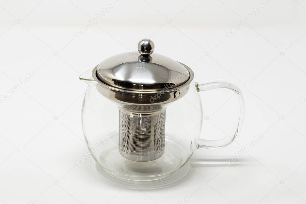 A nempty tea infuser tea pot set against a white background