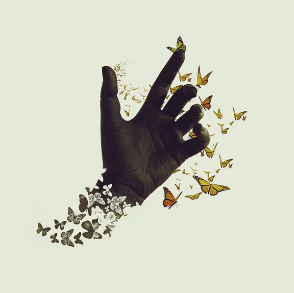 Life transformation concept, butterflies flying out of black hand