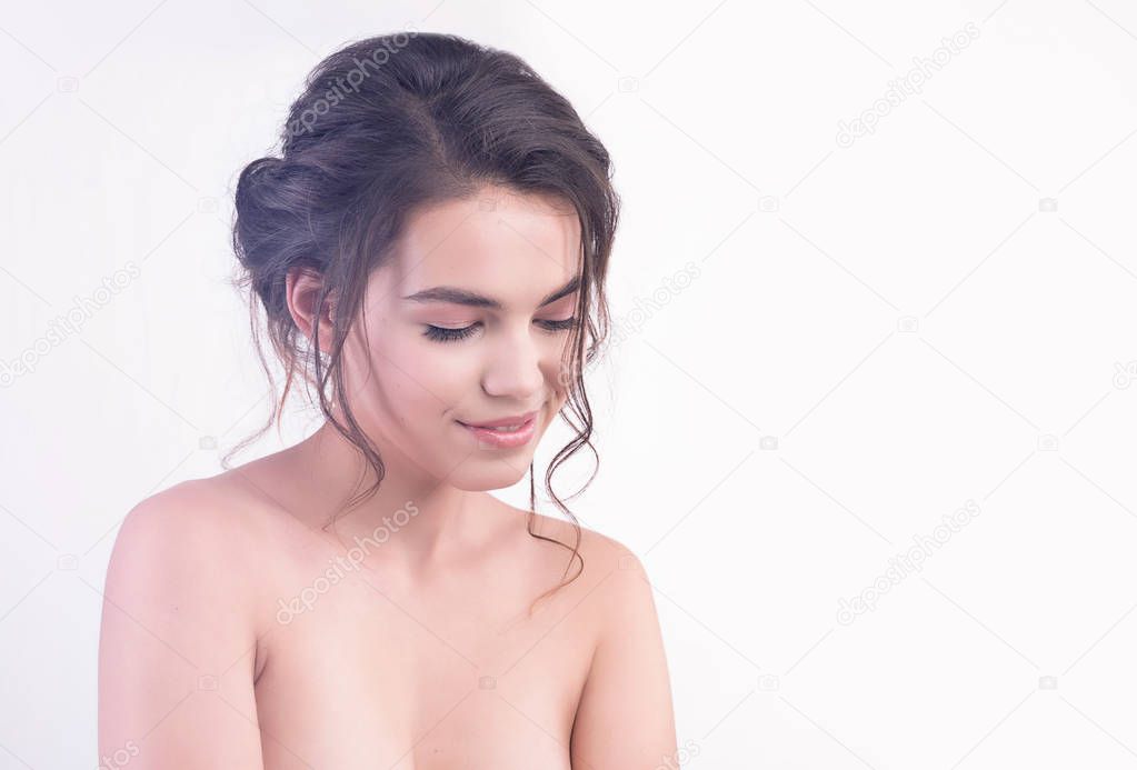 Beautiful face of young woman with clean fresh skin close up isolated on white. Beauty romantic portrait. Spa woman happy smiling. Perfect fresh skin. Pure beauty model. Youth, cosmetics, skin care concept. Positive and cheerful people emotions
