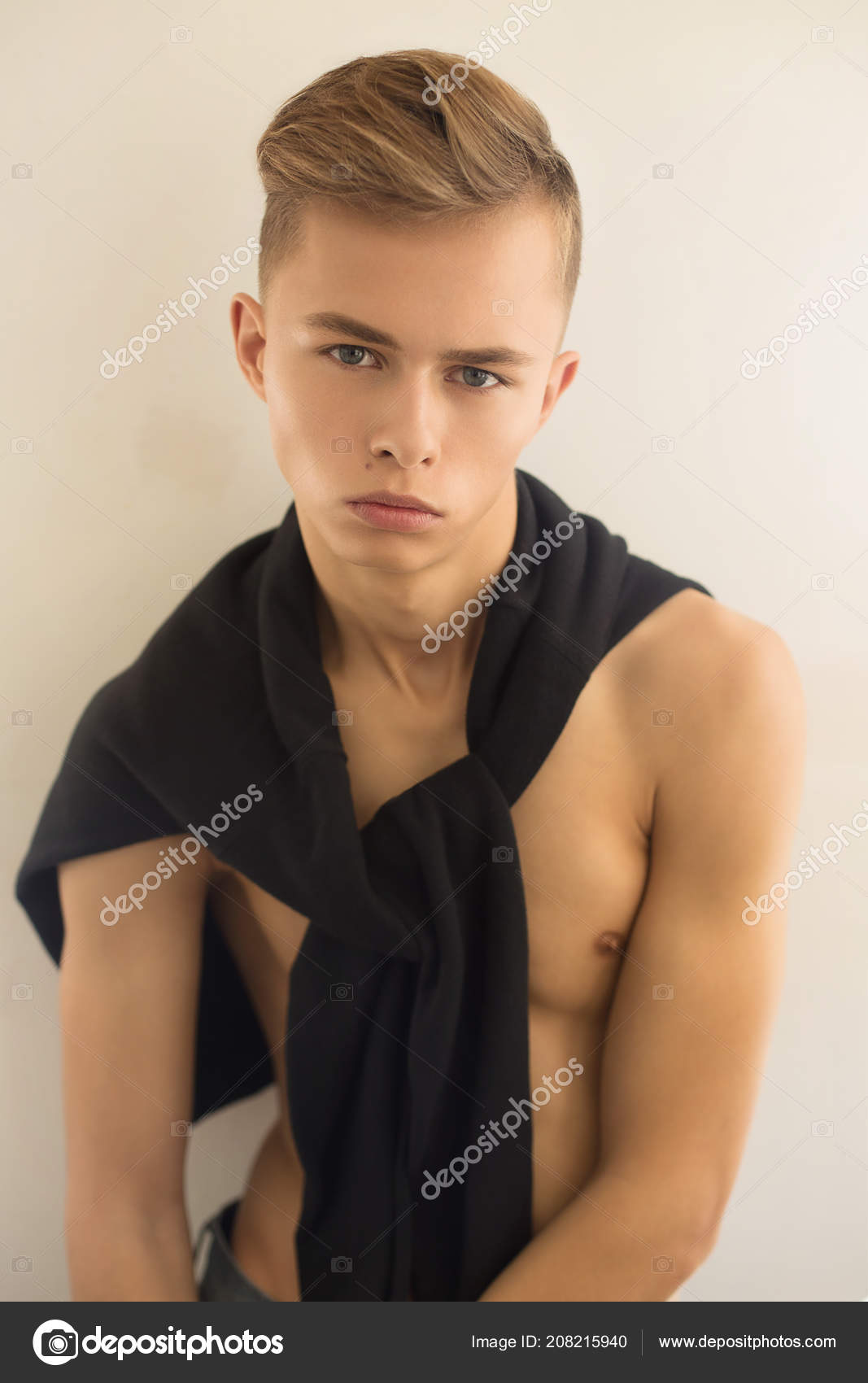Young Man Blonde Hair Wearing Black Sweater His Shoulders Posing
