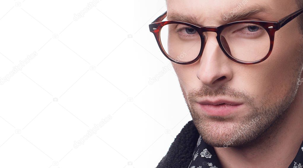 young bearded man in black jacket, pattern shirt and eyeglasses isolated on white background with copy space