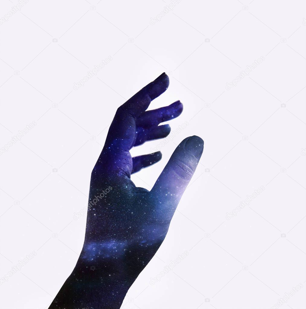Double exposure of hand with texture of colorful space sky with stars