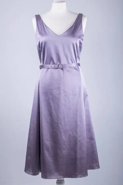 A Tailors Mannequin dressed in a Lilac Satin Dress