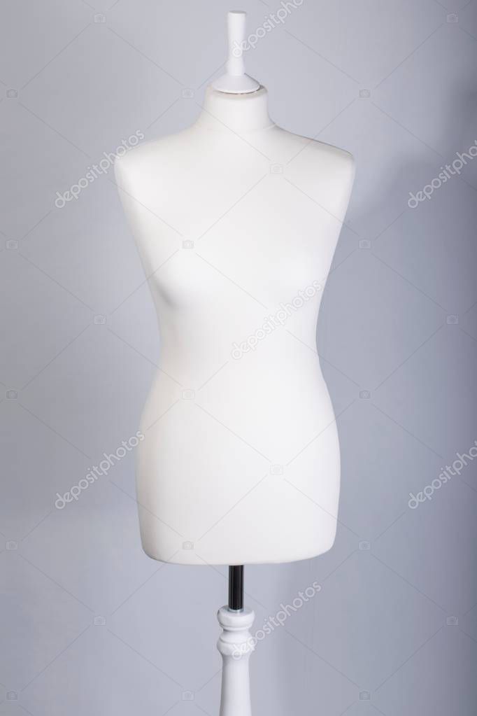 A Tailors Mannequin on a grey background
