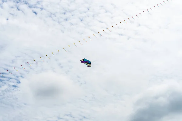 Kites flying in the sky among the clouds.Kite Festival