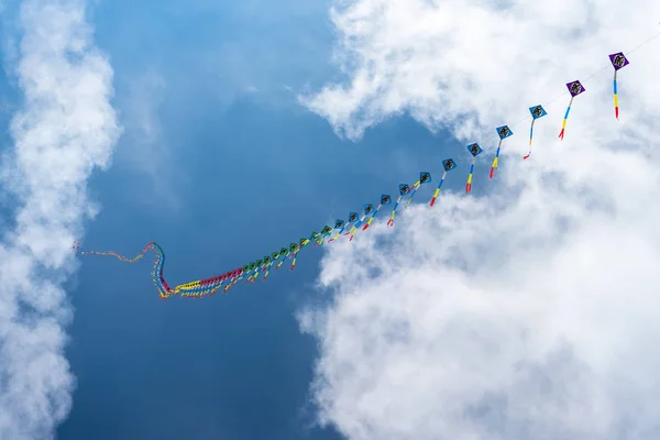 Kites flying in the sky among the clouds.Kite Festival