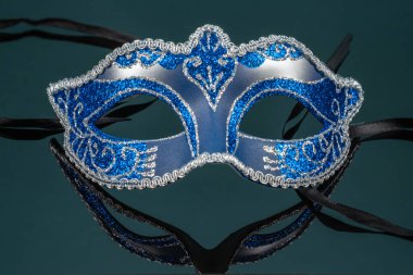 Kolombina, mavi karnaval veya siyah ayna arka planında maskeli balo.