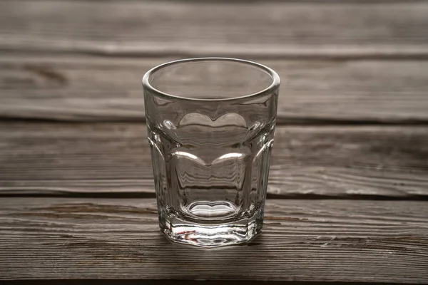 Empty glass standing on a wooden table — Stock Photo, Image