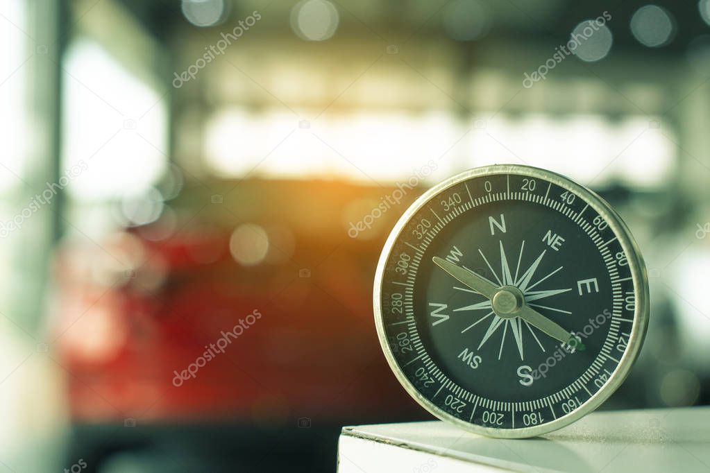 holding compass on blurry background. Using wallpaper or background travel or navigator image.