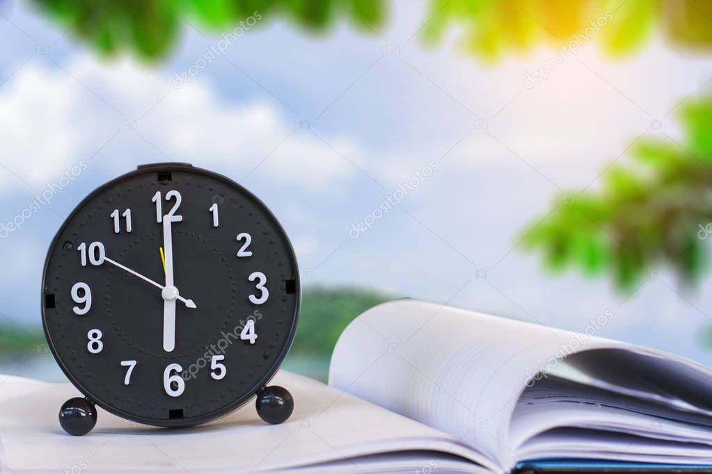 Holding clock on sea blurred background The time 6:00 am or pm and noon or midnight for made clock isolated or White background Copy space move to clipping path
