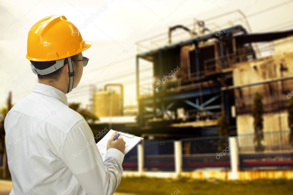 Male engineer inspection checking in factory With note on notepad or industry blurred background.Metaphor Quality inspection or Production speed For the best quality to customers.