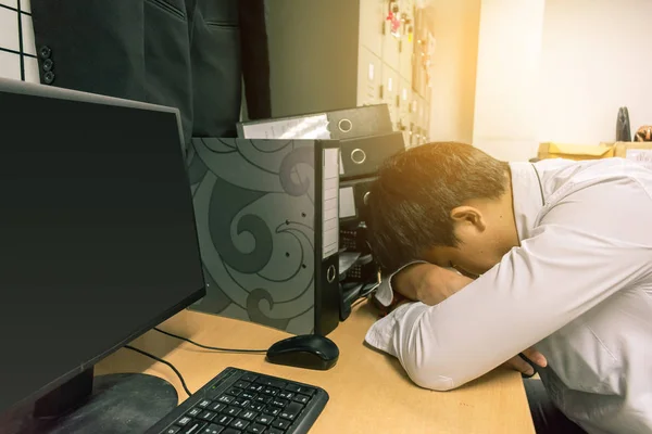 Asian businessman Sleep in office while working computer.Metaphor for fatigue be tired of work to relax image