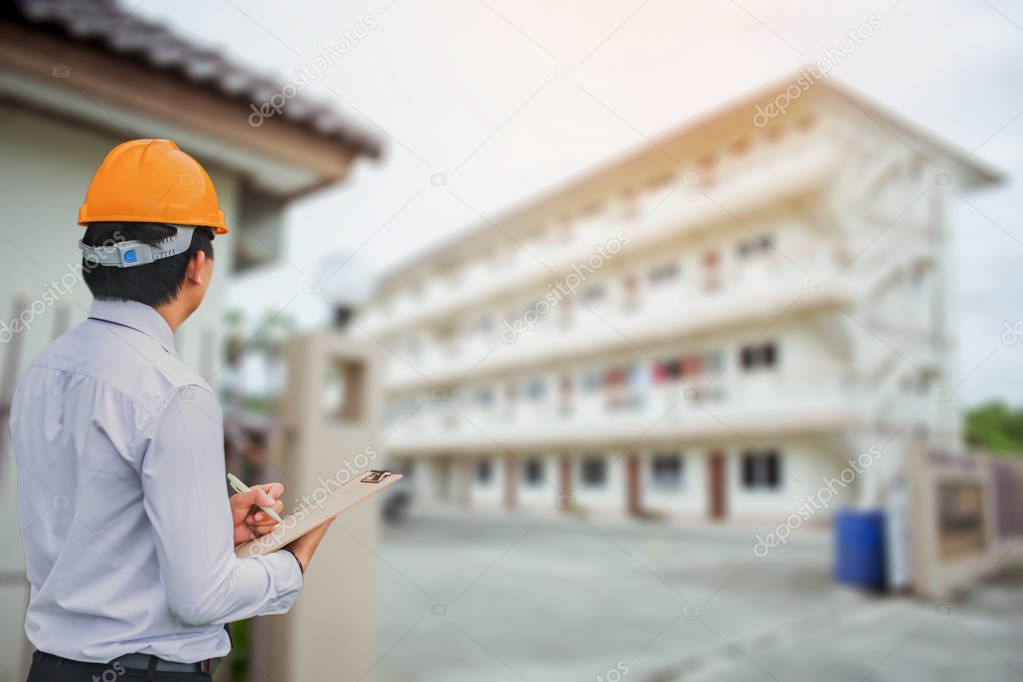Male engineer inspection checking on container background With n