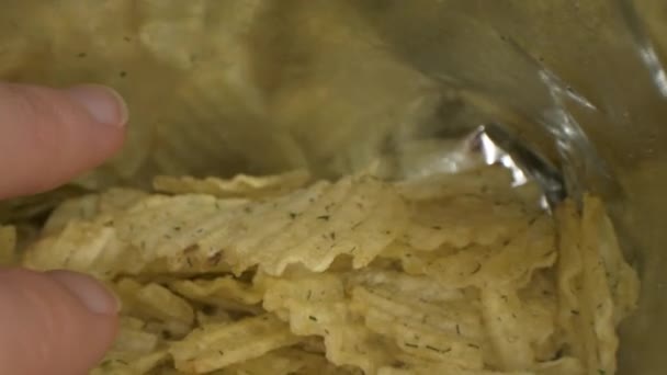 Macro deslizante tiro de mano tomando patatas fritas del paquete. Vista de lente de sonda . — Vídeos de Stock