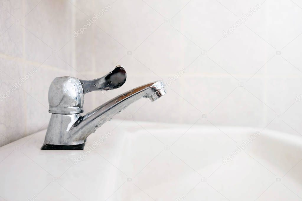 Close up faucet in the bathroom , save water concep