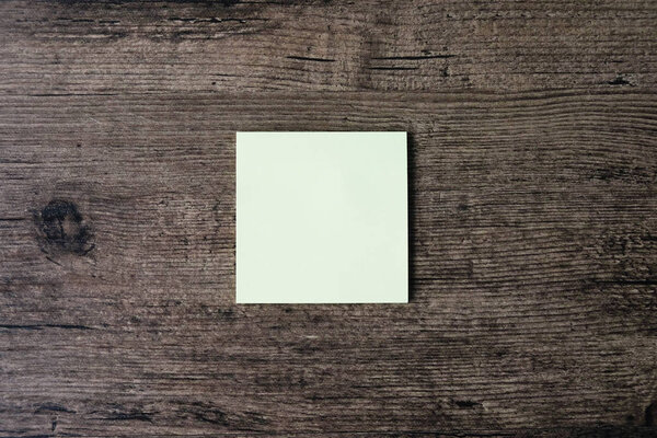 Top view image of empty sticky note paper on the wooden table