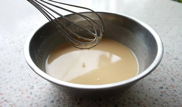 Mixing batter or dough for pancake or making desserts.Close up ,soft focu