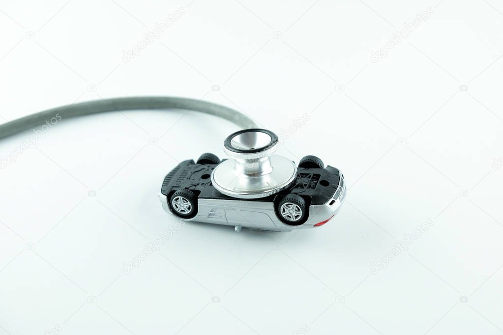 Stethoscope checking up the car on white background, Concept of car check up, repair and maintenance