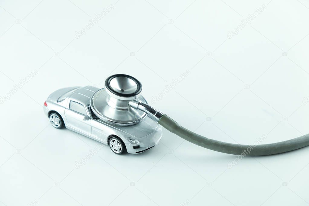 Stethoscope checking up the car on white background, Concept of car check up, repair and maintenance